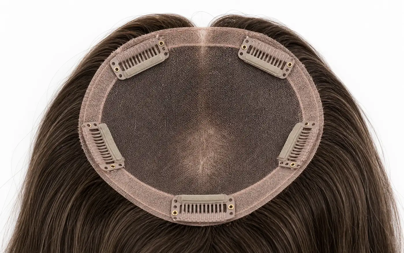 Silicone lined clips securing hair topper on crown with gentle pressure