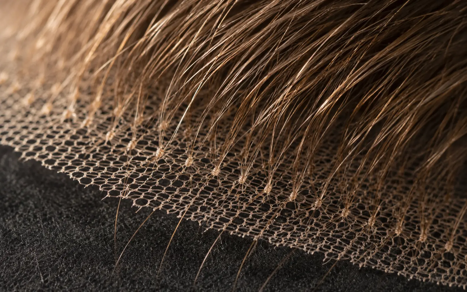 Close-up of Swiss lace mesh with hand-tied European hair strands and bleached knots on a lace front sheitel cap