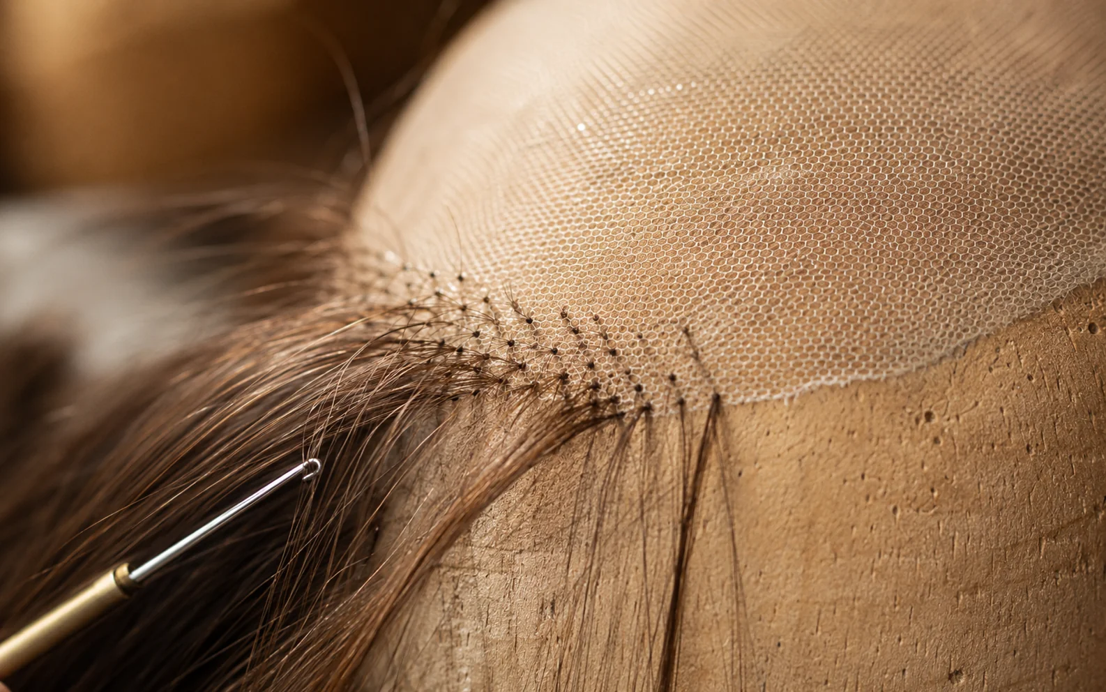 Close-up of Swiss lace cap construction showing individual hair knots hand-tied through fine mesh