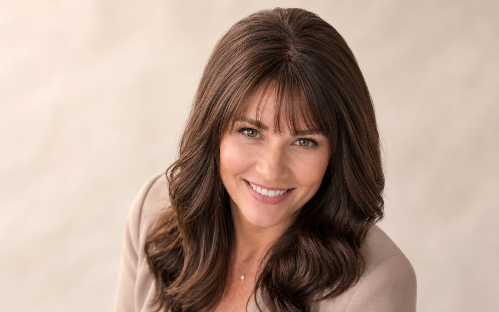 Woman wearing a natural-looking hair topper that blends seamlessly with her own hair at the crown