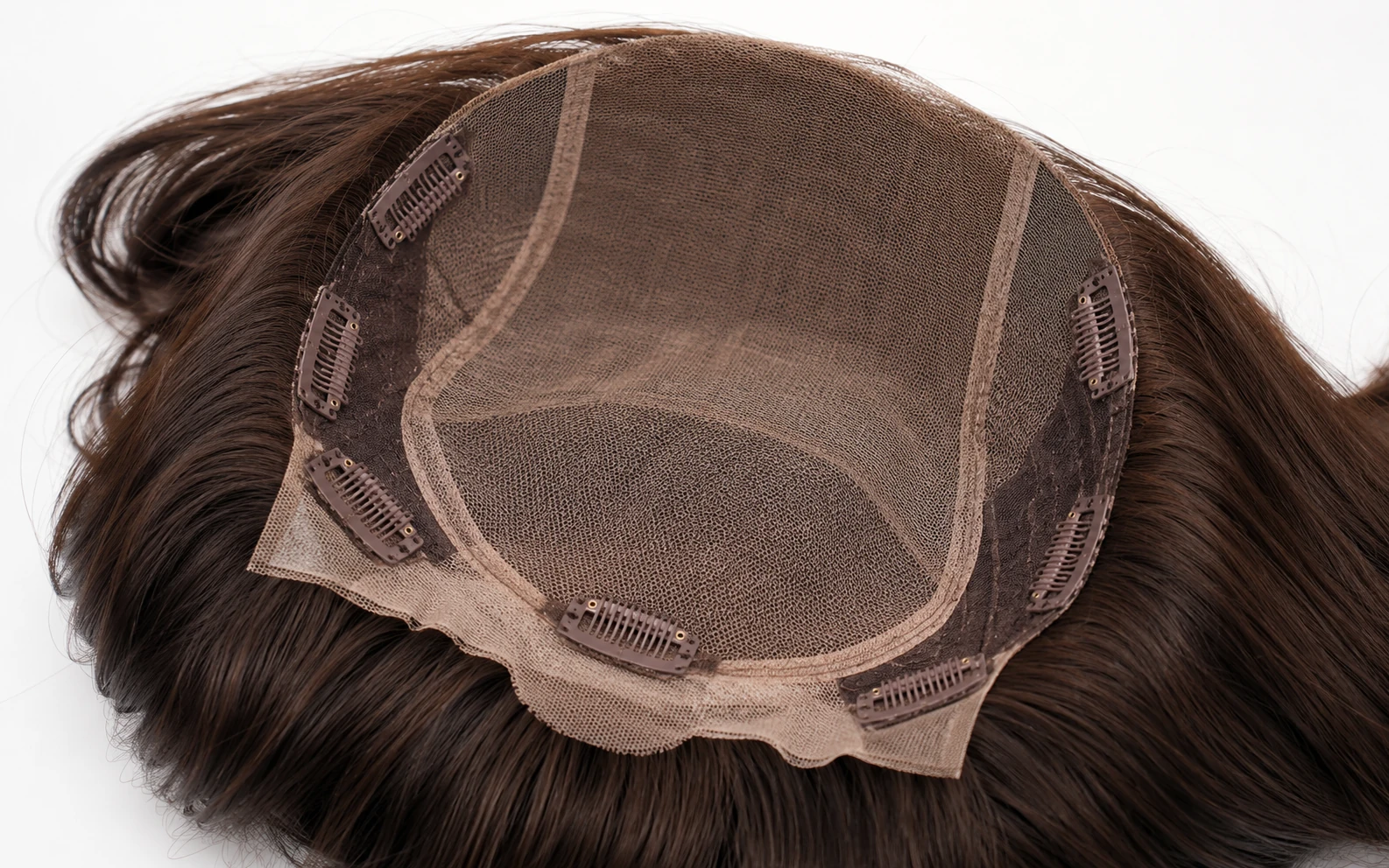 Interior of a sheitel fall cap showing lace panels, reinforced seams, and pressure-sensitive clips
