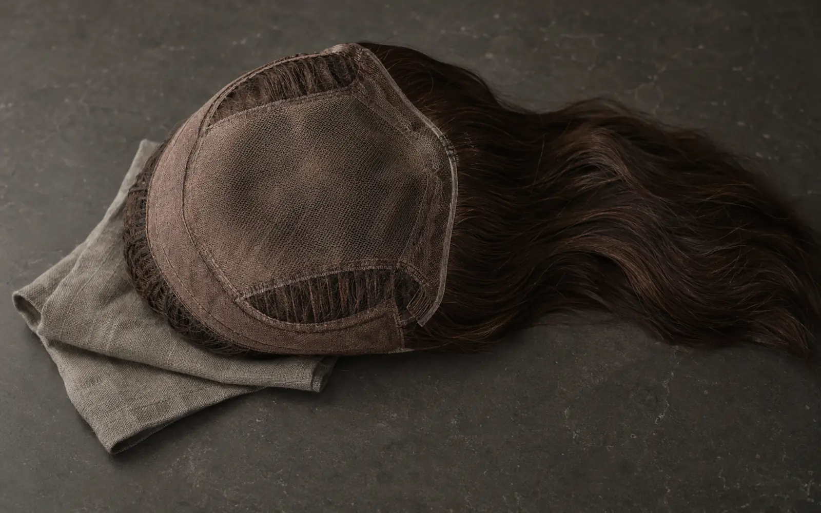 LEV lace top sheitel construction still life showing Swiss lace, hand-tied knots and natural hair fibers