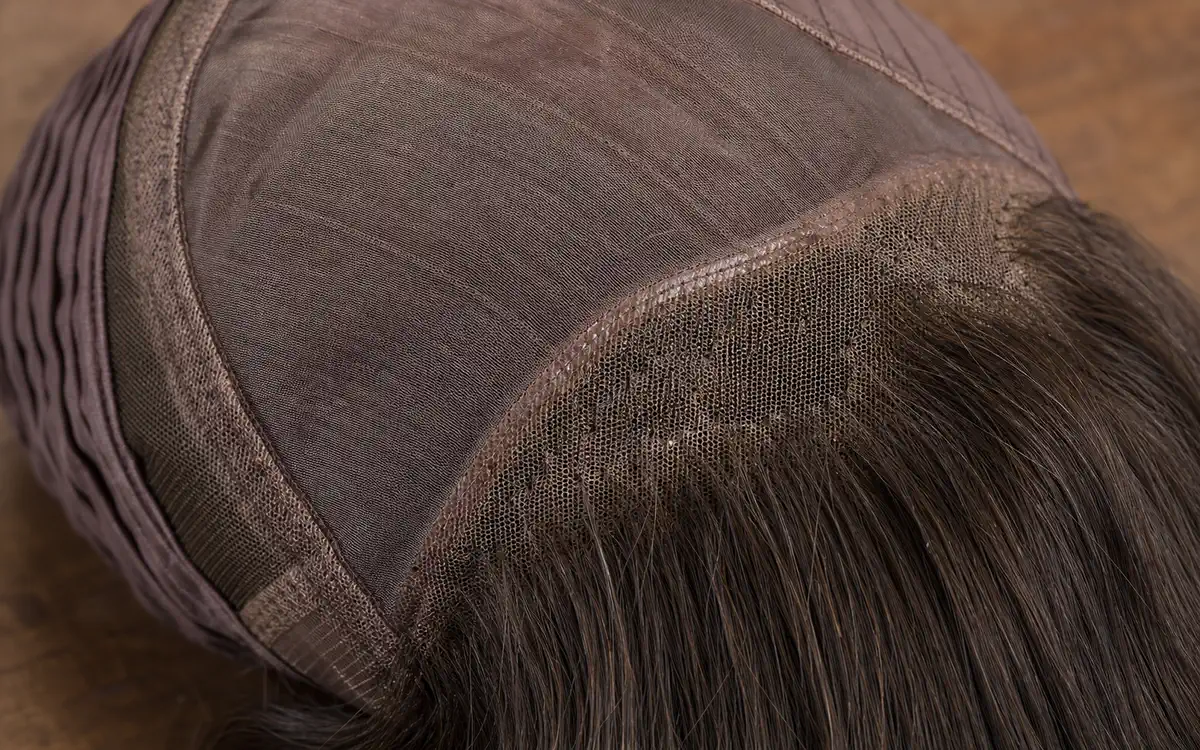 Detail of a jewish female wig cap showing silk top and lace top construction layers