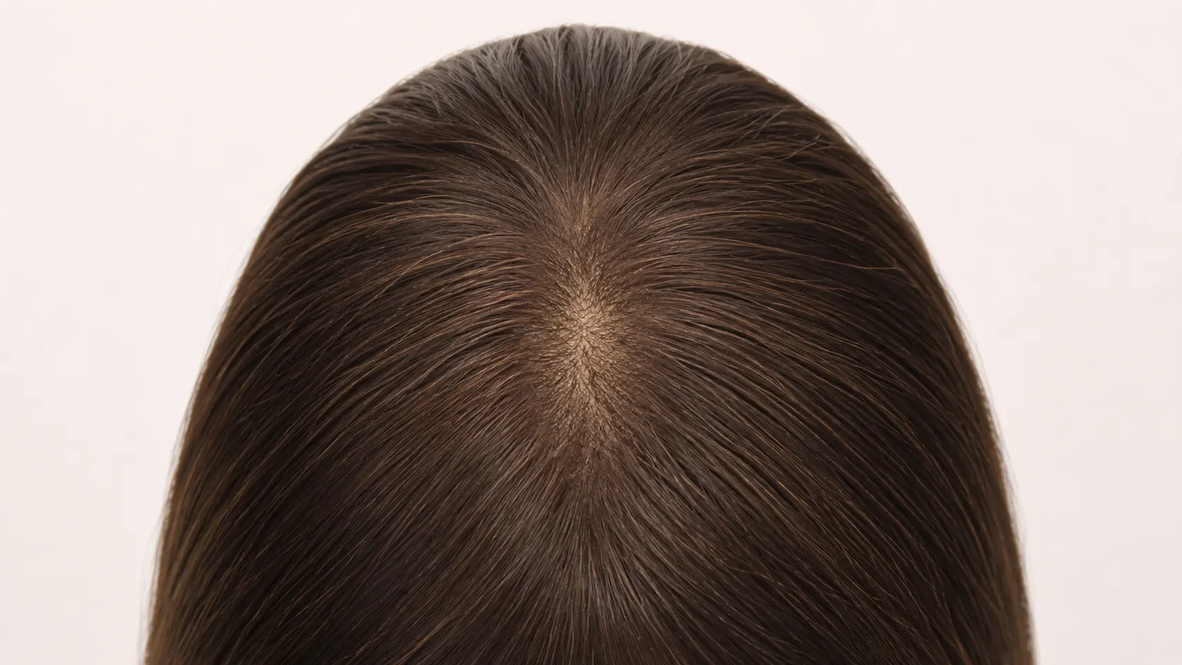 Product view focused on the layered crown area of a brunette silk top sheitel