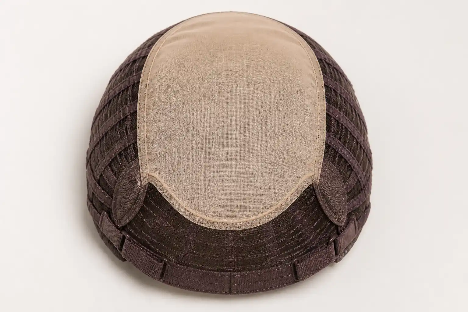 Illustrative inside view of a silk-top sheitel cap showing the pale crown panel, surrounding weft support and adjustable perimeter